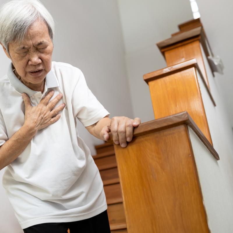 Asian woman clutching chest