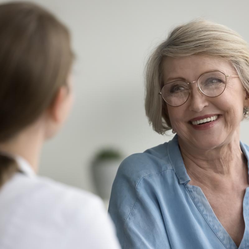 Older female patient talking to doctor